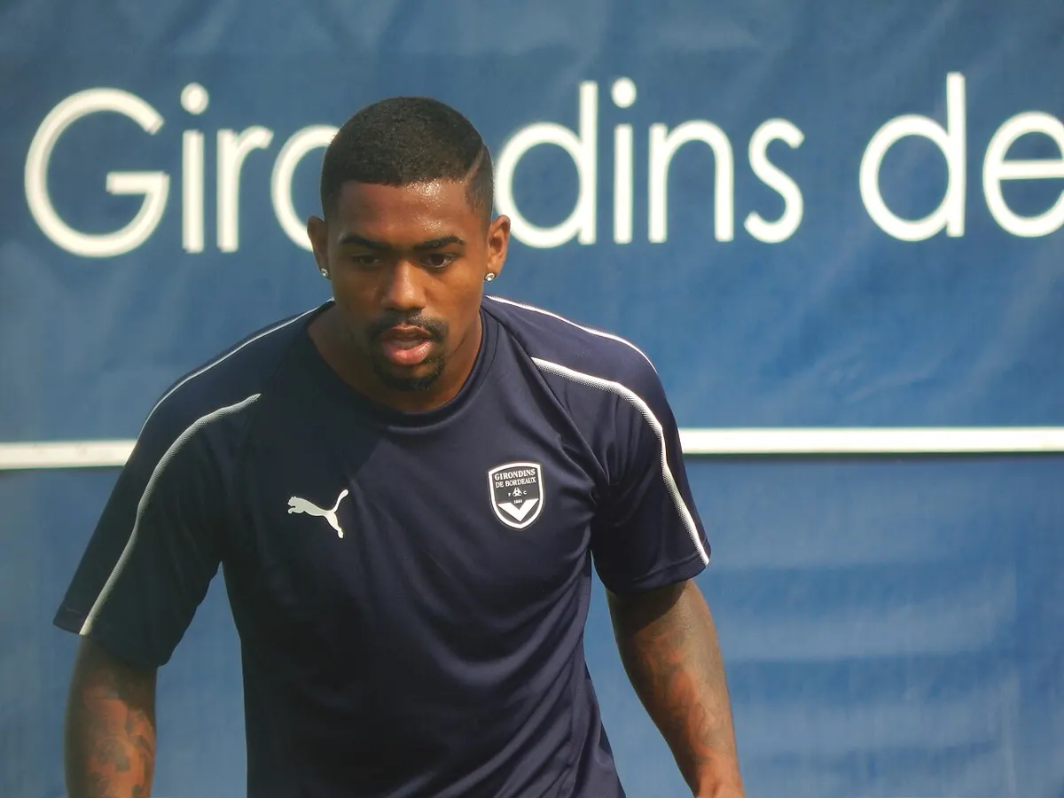 Brazilian forward Malcom, now of Al Jazira, in a navy Girondins de Bordeaux training top during a training session in front of a blue club banner in July 2018