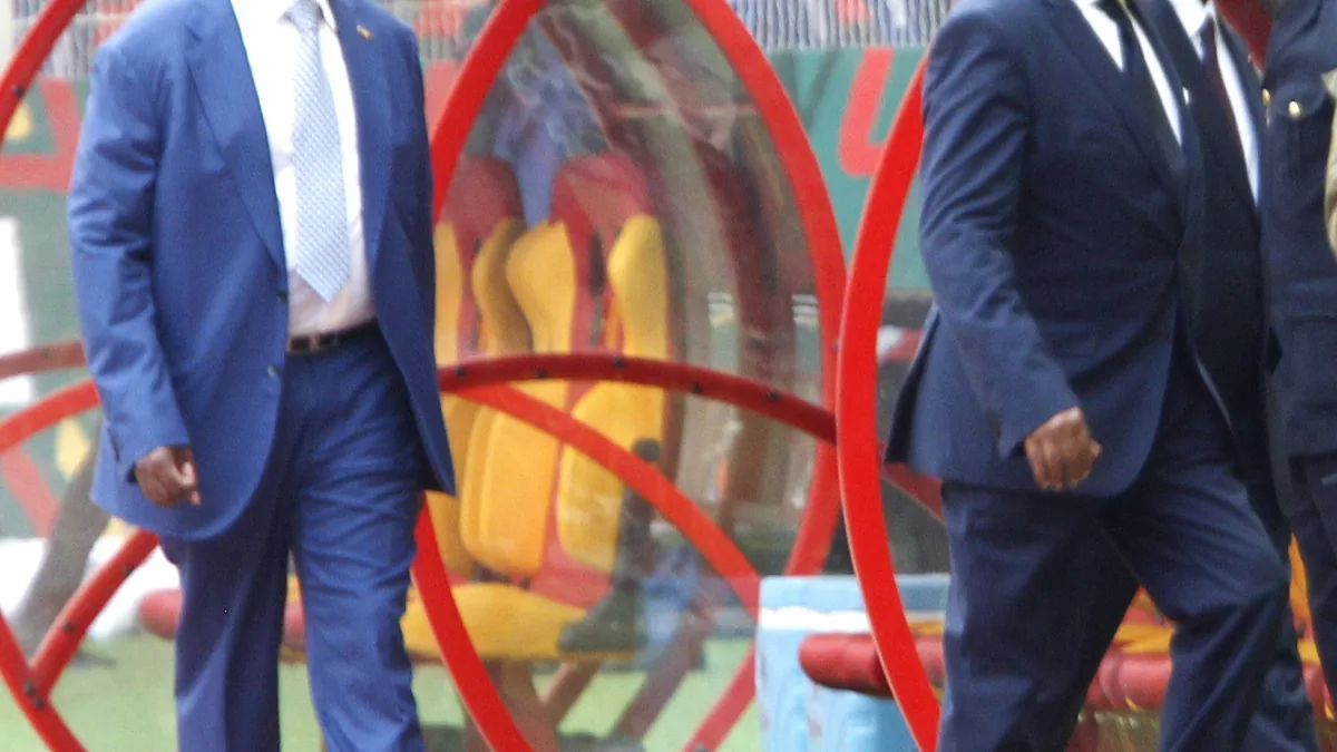 CAF president Patrice Motsepe and FIFA president Gianni Infantino walking past the team benches at the Olembe Stadium in Yaoundé at the Africa Cup of Nations opening in January 2022