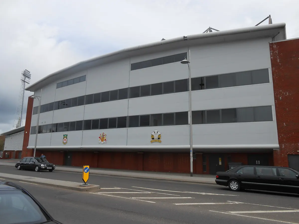 Exterior of a stand at the Racecourse Ground, home of Wrexham AFC, with a floodlight pylon behind