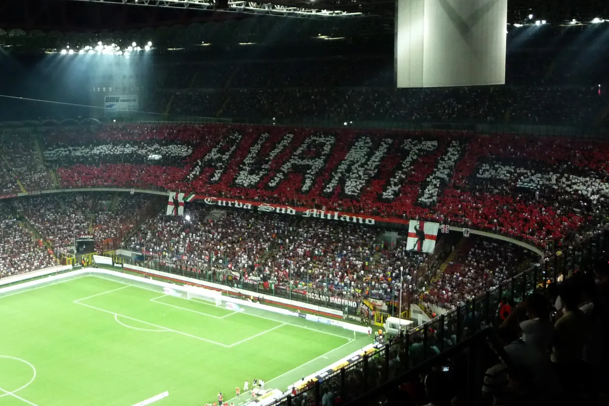 AC Milan fans form a red and black Avanti display in the Curva Sud at San Siro before the Milan derby in August 2009